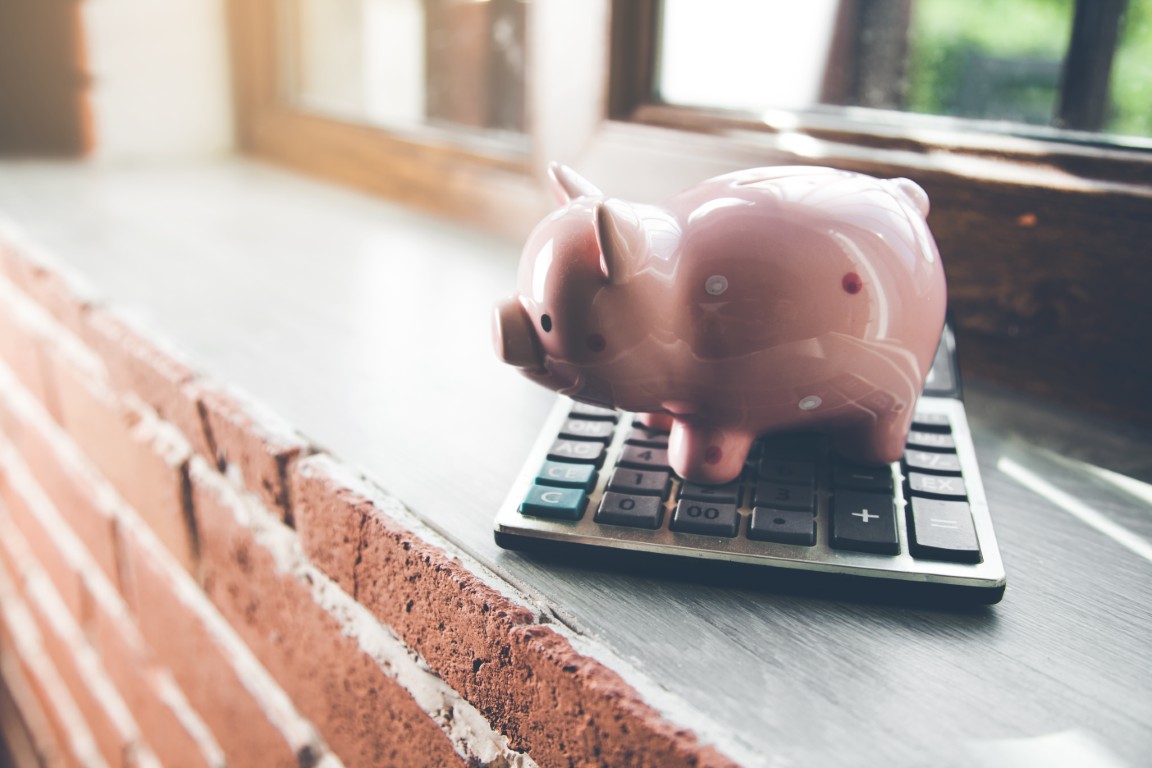 piggy bank with calculator on window